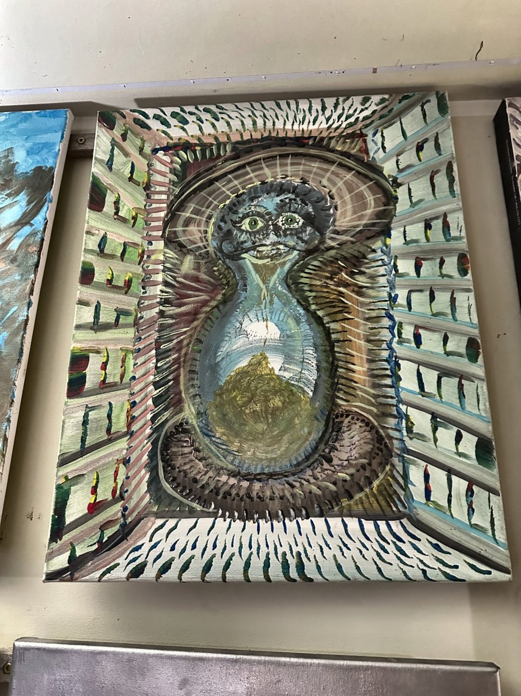 Acrylic painting of a figure inside an hourglass surrounded by folding buildings